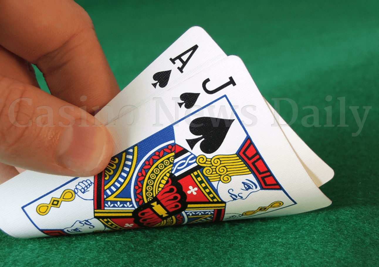 Player holding 21 in handheld blackjack game.