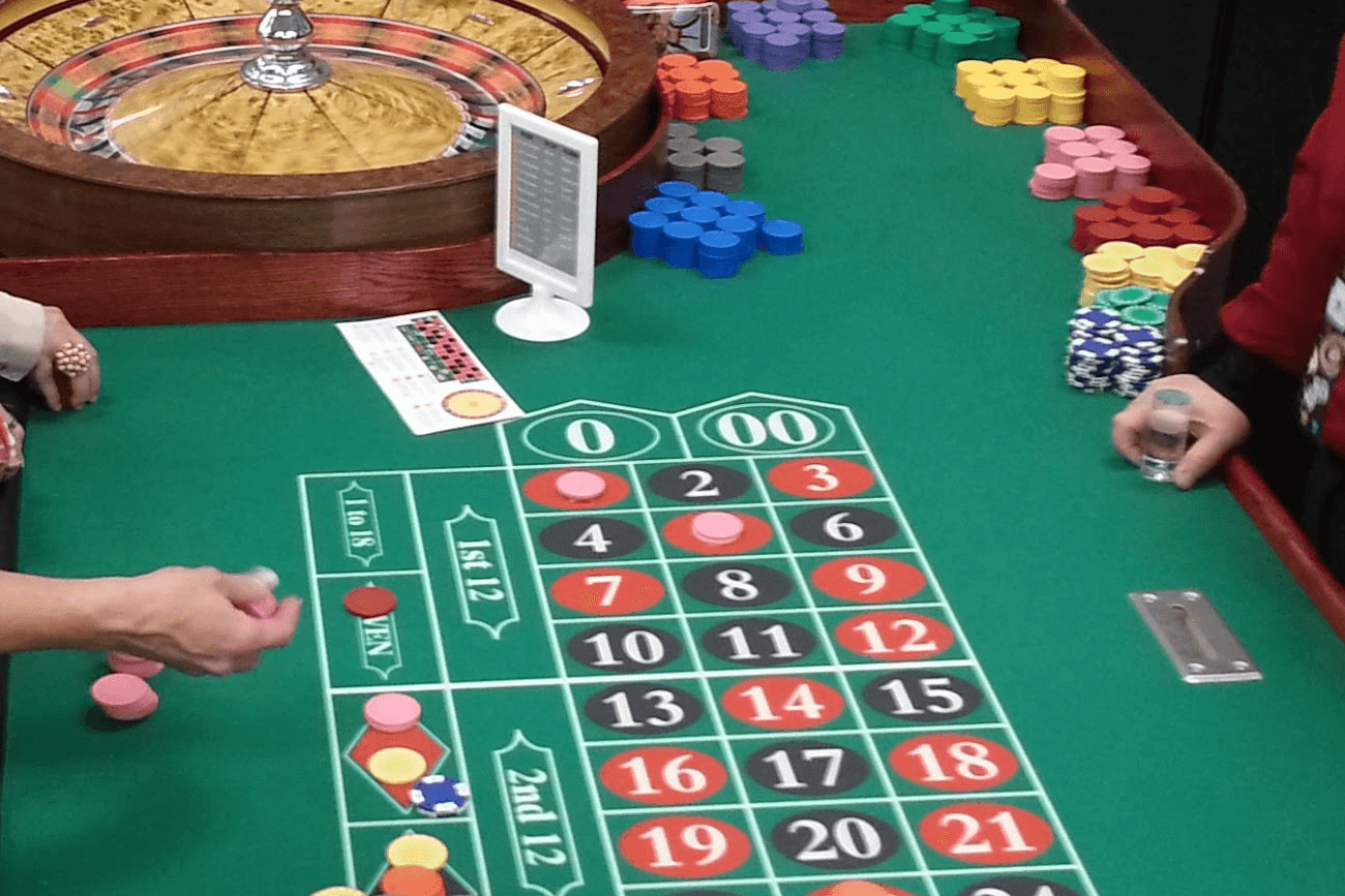 People betting chips on roulette table