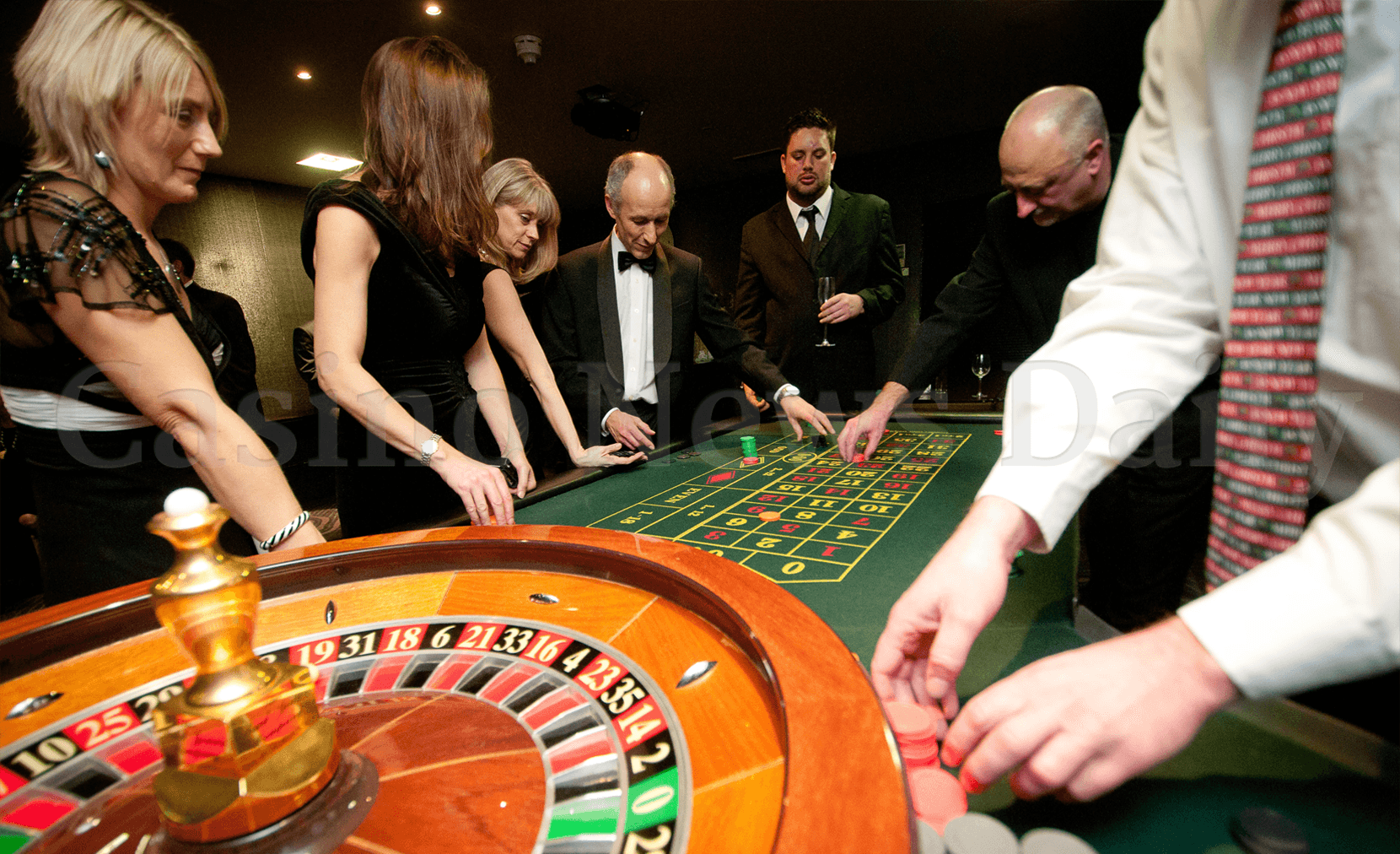 People around casino roulette table